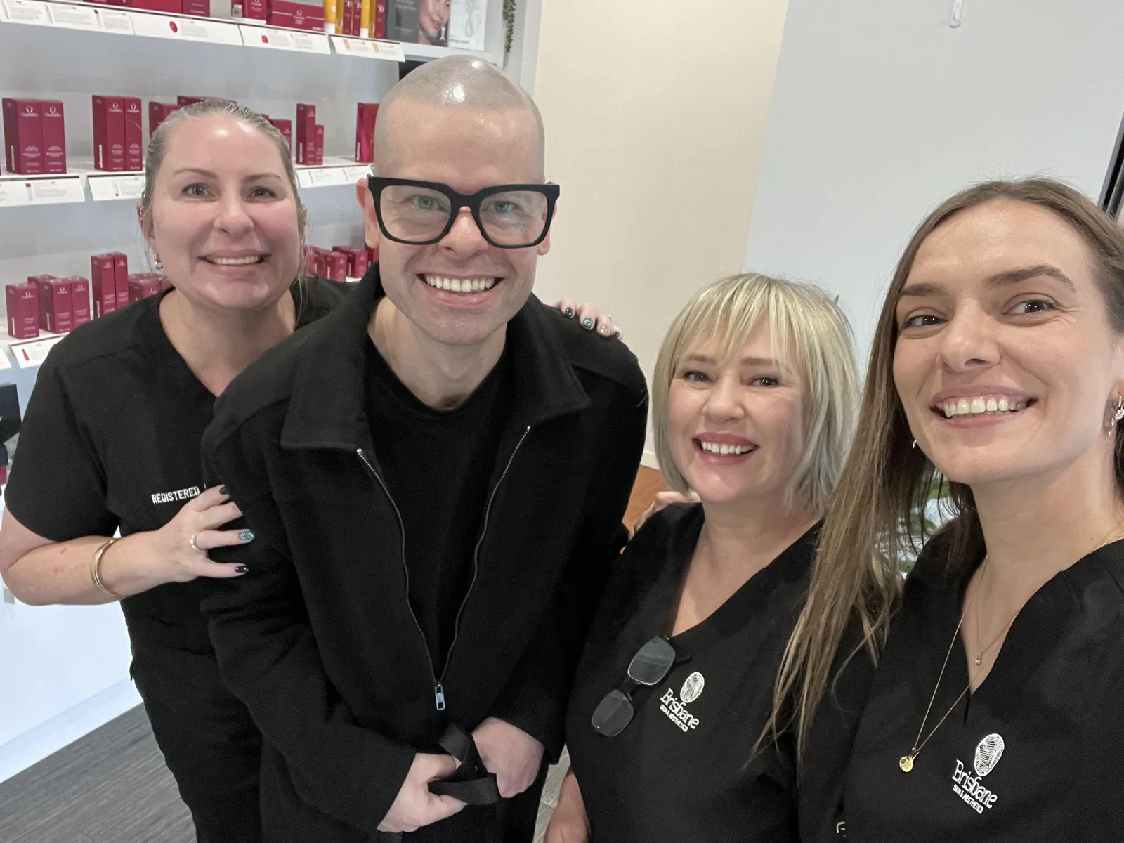 Ben standing with three Brisbane Skin and Aesthetics practitioners at the clinic reception.