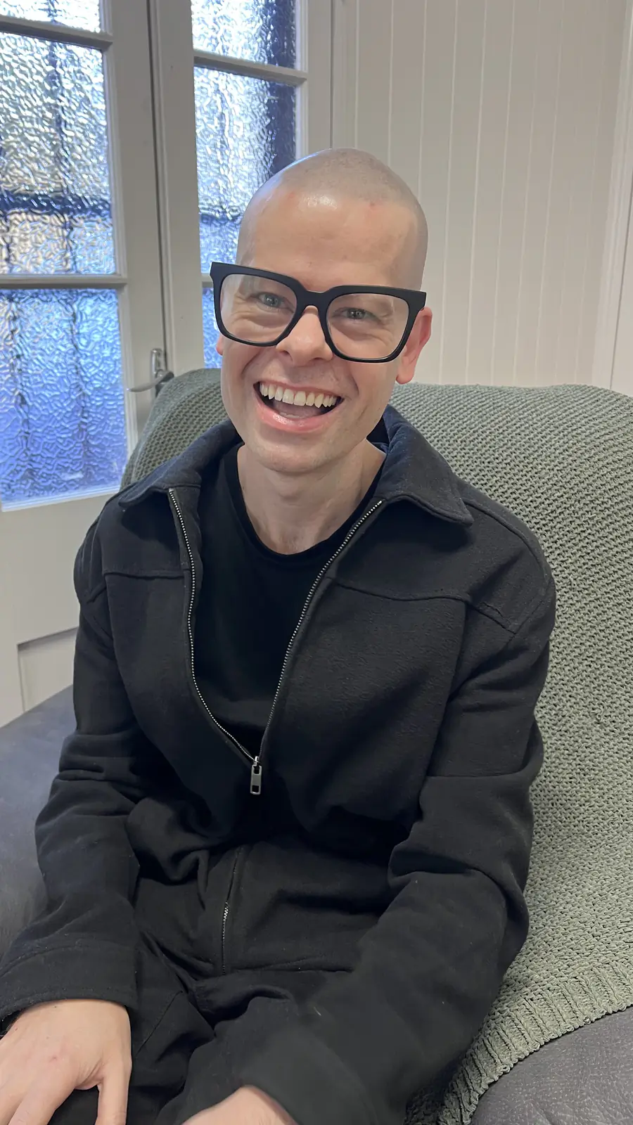 Ben seated on a couch in the clinic waiting area.