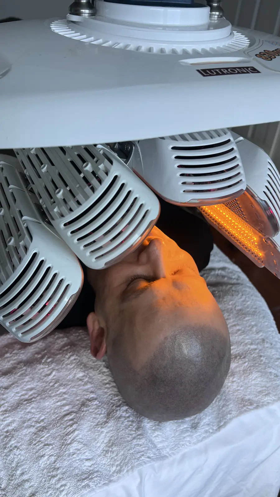 LED light therapy panels positioned over Ben's face during treatment.
